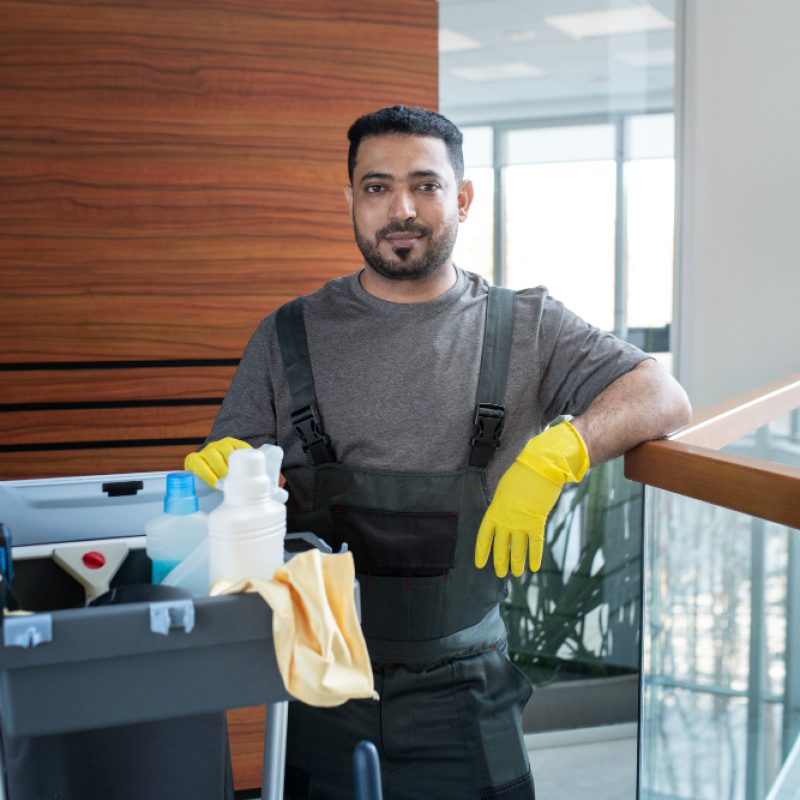 medium-shot-smiley-man-with-cleaning-cart